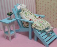 Bunny Doll lounging in blue Adirondack Chair