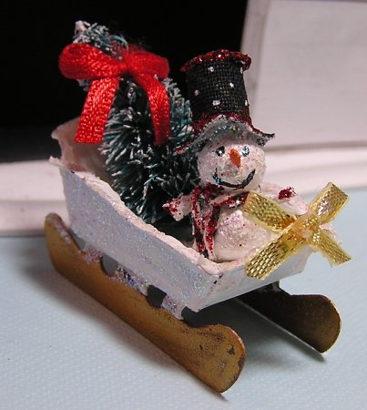 Snowman in sled